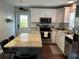 Bright kitchen with white cabinetry, granite countertops, stainless steel appliances, and breakfast bar at 2745 4Th S Ave, St Petersburg, FL 33712