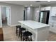 Modern kitchen island with seating, stainless steel appliances, and hardwood floors throughout the home at 2745 4Th S Ave, St Petersburg, FL 33712