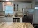 Updated kitchen featuring stainless steel appliances, granite countertops, and stylish white cabinetry at 2745 4Th S Ave, St Petersburg, FL 33712