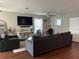 Inviting living room with hardwood floors, a large sectional sofa, and a mounted TV at 2745 4Th S Ave, St Petersburg, FL 33712