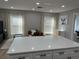 Open-concept space showcases kitchen island leading into living room with modern decor, recessed lights, and natural light at 2745 4Th S Ave, St Petersburg, FL 33712