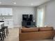 Cozy living room boasts modern finishes, a leather couch, and lots of natural light from the windows at 2745 4Th S Ave, St Petersburg, FL 33712