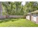 Spacious backyard with privacy fence, shed, and mature trees creates a serene outdoor space at 2818 Cedaridge Dr, Tampa, FL 33618