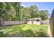 Fenced backyard featuring two storage sheds and grassy lawn, perfect for outdoor activities at 2818 Cedaridge Dr, Tampa, FL 33618