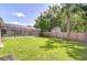Expansive backyard features a screened-in pool, lush green grass and a wood fence for privacy at 2818 Cedaridge Dr, Tampa, FL 33618