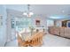 Light-filled dining area with wooden table and chairs, sliding glass doors to the outdoors at 2818 Cedaridge Dr, Tampa, FL 33618