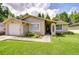 Charming single-story home with a well-manicured lawn and inviting front garden at 2818 Cedaridge Dr, Tampa, FL 33618