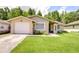 Charming single-story home with a well-manicured lawn and inviting front garden at 2818 Cedaridge Dr, Tampa, FL 33618