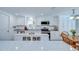 Well-lit kitchen with white cabinets, island, stainless steel appliances, and a view to the dining area at 2818 Cedaridge Dr, Tampa, FL 33618