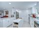 Kitchen showcases white cabinetry, stainless steel refrigerator, and granite countertops with an island at 2818 Cedaridge Dr, Tampa, FL 33618
