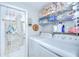 Well-equipped laundry room featuring a washer, dryer, and storage shelves at 2818 Cedaridge Dr, Tampa, FL 33618