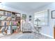 Bright living room featuring built-in bookshelf, chair, and a window that brings in natural light at 2818 Cedaridge Dr, Tampa, FL 33618