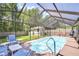 Relaxing screened-in pool area with outdoor seating, ideal for entertaining and enjoying the outdoors at 2818 Cedaridge Dr, Tampa, FL 33618