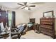 This bedroom features a dark wood furniture set and a ceiling fan at 2901 50Th E Pl, Bradenton, FL 34203
