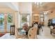 Bright dining area with poolside views, adorned with elegant chandelier and stylish table setting at 2901 50Th E Pl, Bradenton, FL 34203