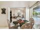 Dining room features a glass table and view into the spacious living room and pool area at 2901 50Th E Pl, Bradenton, FL 34203