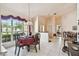 Dining room with elegant chandelier, large window, and tile flooring at 2901 50Th E Pl, Bradenton, FL 34203