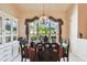Close-up of the dining room features a large window with lush outdoor views and stylish decor at 2901 50Th E Pl, Bradenton, FL 34203