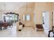 Welcoming foyer features tile flooring, a decorative light fixture, and view of a window and the dining room at 2901 50Th E Pl, Bradenton, FL 34203