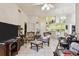 Large living room open to kitchen featuring white cabinetry and modern appliances at 2901 50Th E Pl, Bradenton, FL 34203