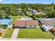 Aerial view of the home, grounds, swimming pool and surrounding neighborhood with lush trees at 302 Patty Dr, Oldsmar, FL 34677
