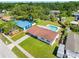 Aerial view of the home and back yard featuring a pool, patio, large trees and surrounding neighborhood at 302 Patty Dr, Oldsmar, FL 34677
