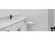 Bathroom featuring a modern sink, black hardware, quartz countertop, and toilet at 302 Patty Dr, Oldsmar, FL 34677