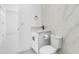 Modern bathroom featuring a sleek vanity, toilet, and marble-style tiled walls at 302 Patty Dr, Oldsmar, FL 34677