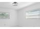 Bright bedroom with two windows and neutral walls, providing ample natural light at 302 Patty Dr, Oldsmar, FL 34677