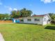 Charming single-story home featuring a well-maintained lawn, mature trees, and classic architecture at 302 Patty Dr, Oldsmar, FL 34677