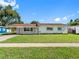 Single-story home featuring a well-manicured lawn and classic architecture in a suburban setting at 302 Patty Dr, Oldsmar, FL 34677