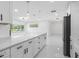 Kitchen with a large island and stainless steel appliances is open to the living room at 302 Patty Dr, Oldsmar, FL 34677