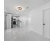 Bright living room with modern lighting and an open view into a modern kitchen at 302 Patty Dr, Oldsmar, FL 34677