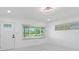 Bright living room with modern lighting, fresh white paint, and sleek marble-look floors at 302 Patty Dr, Oldsmar, FL 34677