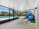 Enclosed patio area featuring a picnic table, seating, and pool view at 302 Patty Dr, Oldsmar, FL 34677