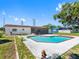 Backyard view of the swimming pool, patio area and well maintained lawn for relaxing outdoor entertainment at 302 Patty Dr, Oldsmar, FL 34677