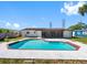 View of the swimming pool and patio area from the home's backyard with an screened in porch at 302 Patty Dr, Oldsmar, FL 34677