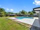 Well-maintained pool, patio area and backyard features a beautiful lawn space and a fenced in perimeter at 302 Patty Dr, Oldsmar, FL 34677