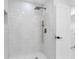 Modern shower with marble-style tile and rainfall shower head at 302 Patty Dr, Oldsmar, FL 34677