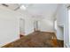 Large living room with hardwood floors and ceiling fans. Needs work at 3108 Dupont S St, Gulfport, FL 33707