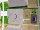 Aerial of the house, showing the roof, yard, playset and garden in a neatly fenced backyard at 33524 Elm Hill Br, Wesley Chapel, FL 33545