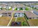 Aerial view of fenced backyard with play set, garden, and well-maintained lawn at 33524 Elm Hill Br, Wesley Chapel, FL 33545