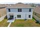 Aerial view of the backyard with a patio, well-maintained lawn, and landscaping with easy access through sliding glass doors at 33524 Elm Hill Br, Wesley Chapel, FL 33545