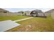 Large backyard with a playset for children and a spacious grassy area, perfect for outdoor activities at 33524 Elm Hill Br, Wesley Chapel, FL 33545