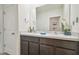 Bathroom features a double sink vanity with modern faucets and decorative accents, and a large mirror at 33524 Elm Hill Br, Wesley Chapel, FL 33545