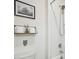 A modern bathroom featuring a shower with tiled walls, sleek fixtures, and a decorative wall shelf at 33524 Elm Hill Br, Wesley Chapel, FL 33545