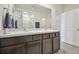Spacious bathroom featuring a double sink vanity and shower with bright lighting at 33524 Elm Hill Br, Wesley Chapel, FL 33545