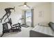 Bright bedroom featuring neutral walls and carpet, a ceiling fan, and workout equipment at 33524 Elm Hill Br, Wesley Chapel, FL 33545