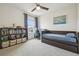 Cozy bedroom with a trundle bed, decorative bookshelf, and lots of room for a desk at 33524 Elm Hill Br, Wesley Chapel, FL 33545