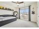 Bedroom with a unique hanging chair by the window, built-in shelves, and a comfortable bed at 33524 Elm Hill Br, Wesley Chapel, FL 33545